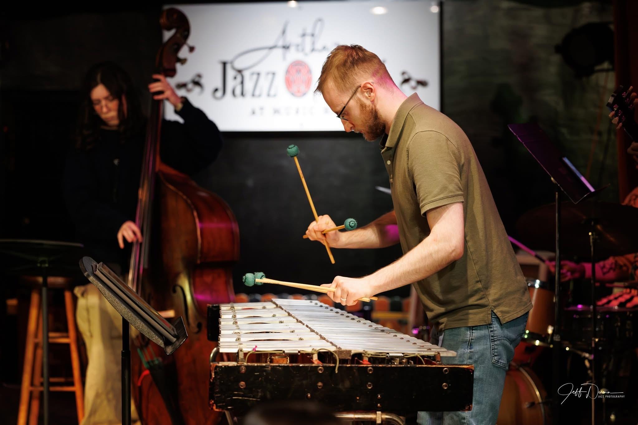 Spencer Perilloux performing mallet percussion with a chamber ensemble.