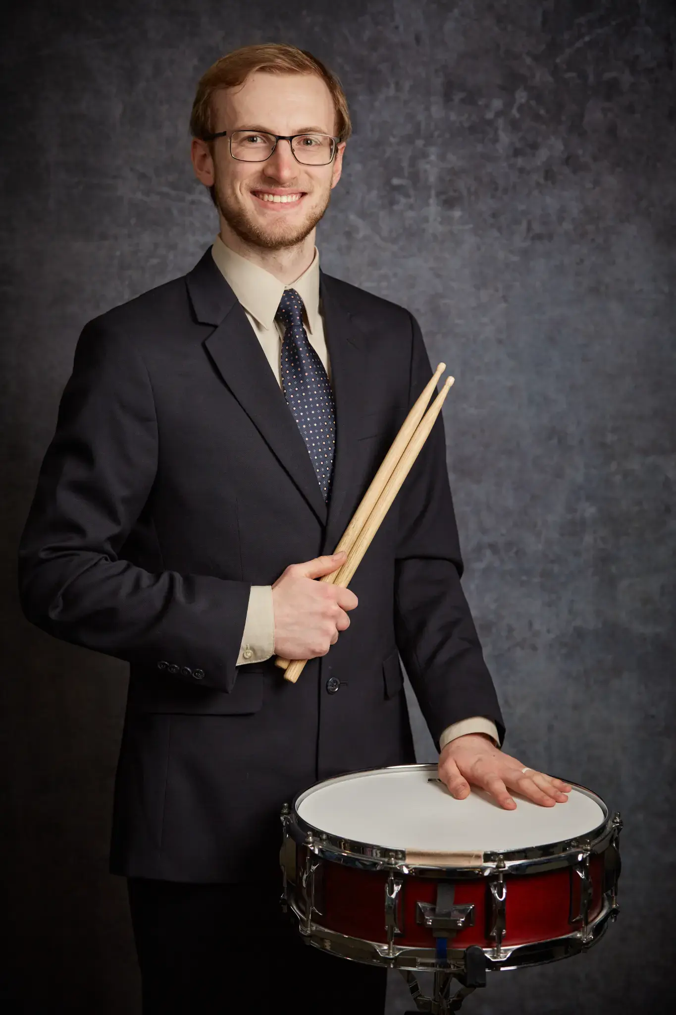 Portrait of Spencer Perilloux holding drumsticks.