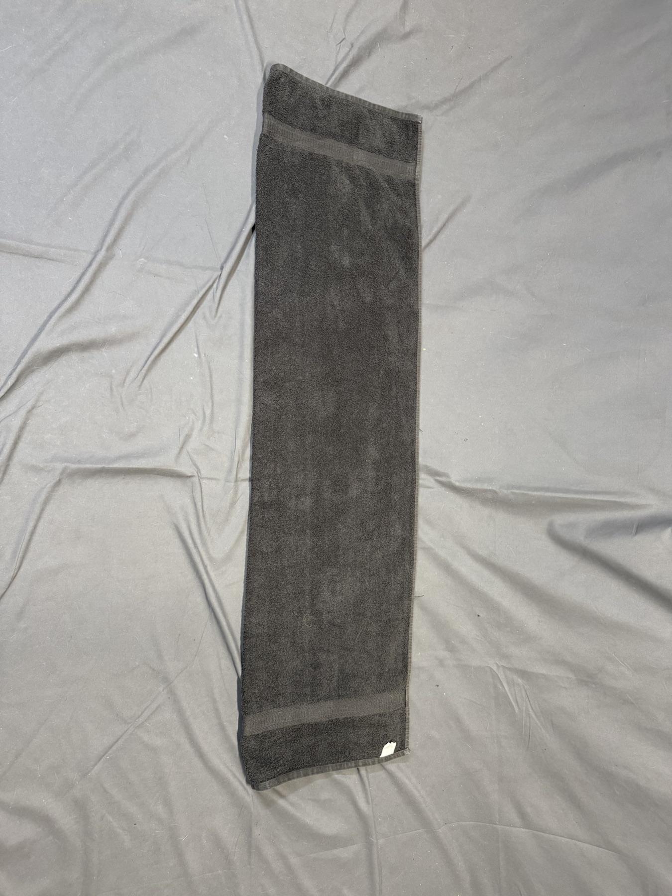 A bath towel folded in half lengthwise.