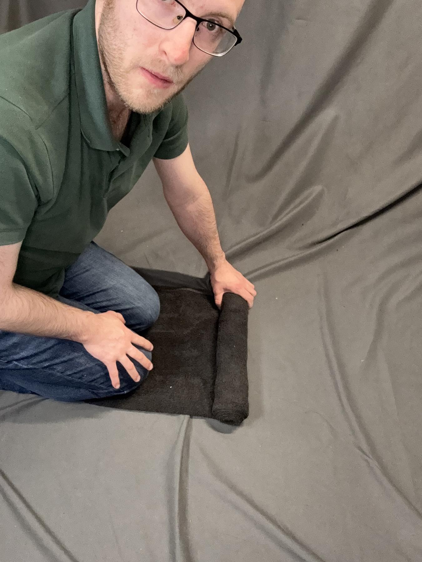 The towel roll being compressed tightly.