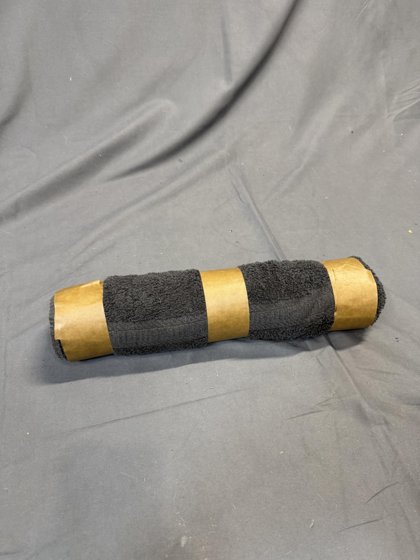 A completed towel roll secured with three bands of tape.