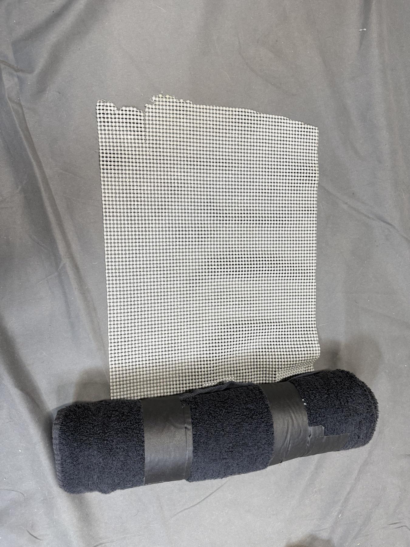 Cabinet liner positioned behind the completed towel roll.
